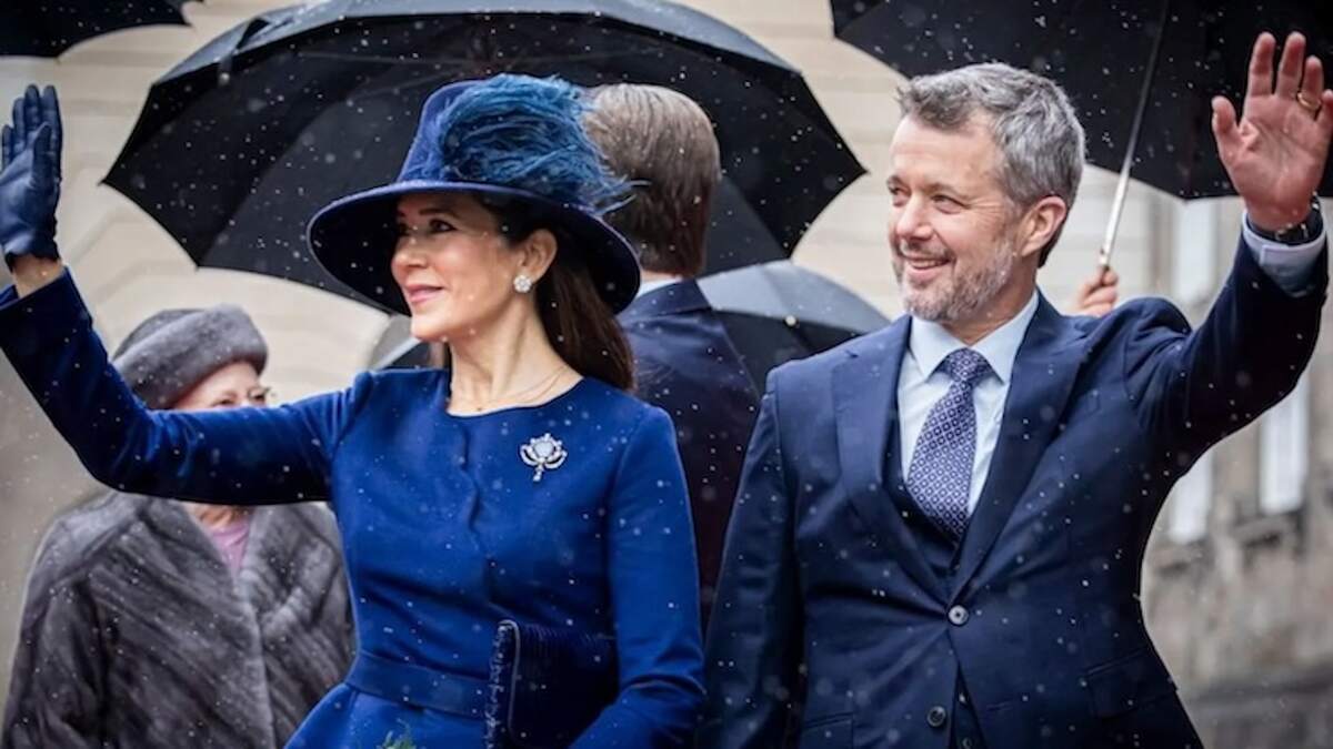 King Frederik X and Queen Mary of Denmark waving in the snow